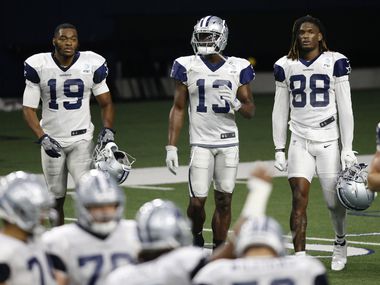 Dallas Cowboys wide receiver Amari Cooper (19), Dallas Cowboys wide receiver Michael Gallup (13) and Dallas Cowboys wide receiver CeeDee Lamb (88) in between plays during training camp inside the Ford Center at the Dallas Cowboys headquarters at The Star in Frisco, Texas on Tuesday, August 18, 2020.