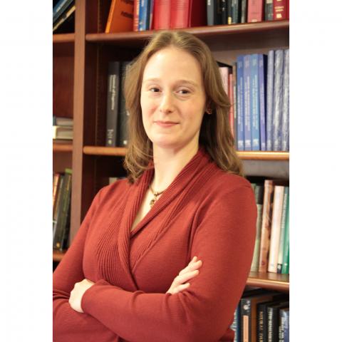 Head shot of Dr. Jeanne Zanca standing next to a bookcase 