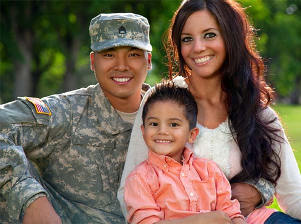 military family with man in uniform, his wife and their young son