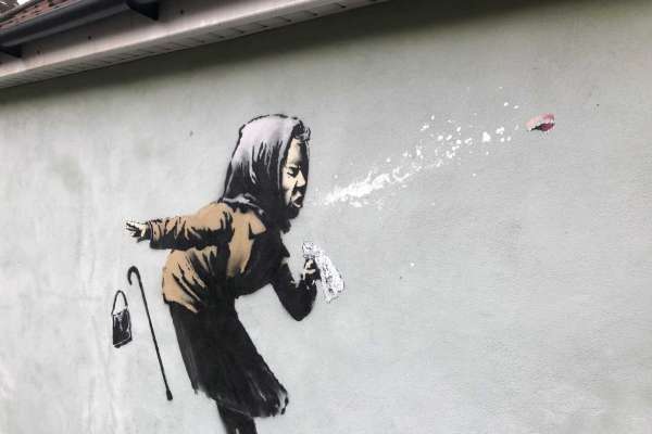 Banksy's latest mural titled "Aachoo!!" that has appeared on a wall in Bristol, England, Thursday Dec. 10, 2020. Banksy's latest mural has delayed - but not thwarted - a homeowner's plans to sell in Bristol after it recently appeared on the house's exterior wall. (Claire Hayhurst/PA via AP)
