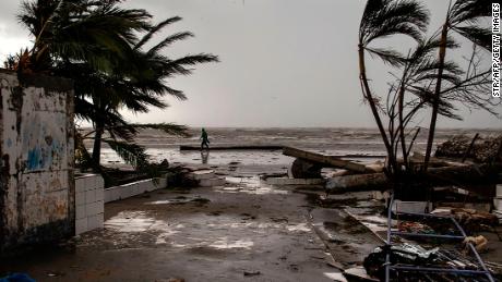 A man walks on the beach after the passage of Hurricane Iota in Bilwi, Nicaragua on November 17, 2020. - Storm Iota has killed at least nine people as it smashed homes, uprooted trees and swamped roads during its destructive advance across Central America, authorities said Tuesday, just two weeks after Hurricane Eta devastated parts of the region. (Photo by STR / AFP) (Photo by STR/AFP via Getty Images)