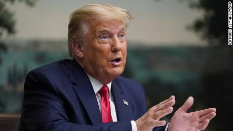 President Donald Trump speaks with reporters after participating in a video teleconference call with members of the military on Thanksgiving, Thursday, Nov. 26, 2020, at the White House in Washington. (AP Photo/Patrick Semansky)