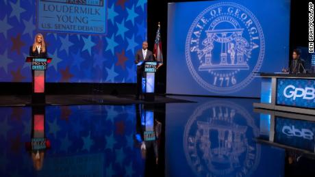 Sen. Kelly Loeffler, left, and Democratic challenger for U.S. Senate Raphael Warnock, second from left, appear during a debate Sunday, Dec. 6, 2020, in Atlanta. (AP Photo/Ben Gray, Pool)