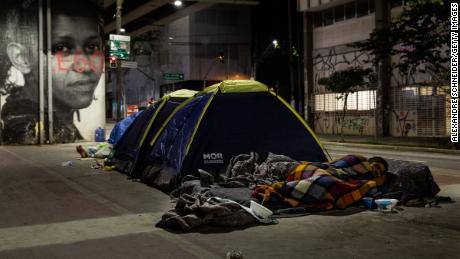 Homeless people sleep in tents in the sidewalk in downtown on August 28, 2020 in Sao Paulo, Brazil.  Due to the pandemic, unemployment is rising and the number of people living on the streets has increased considerably. 