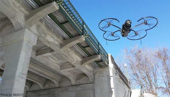 Flying drone inspects bridge improves transportation performance by advancing innovation.