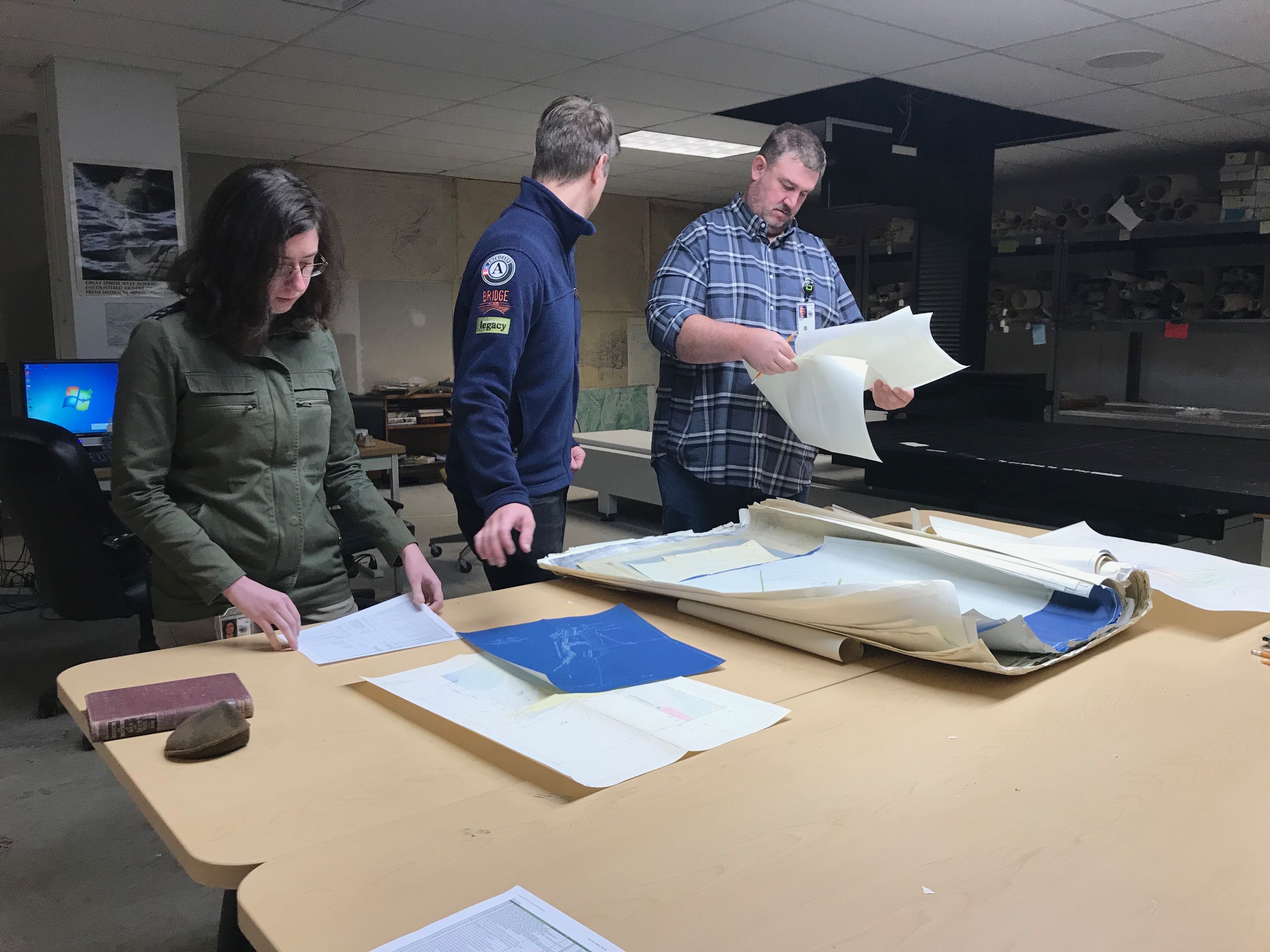 NMMR staff assessing a new donation of mine maps.