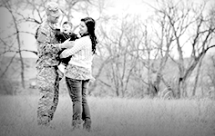 A family of three with the husband in military outfit