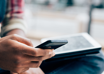 Person using cellphone to look at NSOPW app