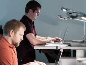 Men working on laptops.