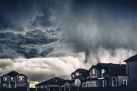 storm clouds with houses in the foreground