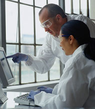 Scientists looking at a computer.