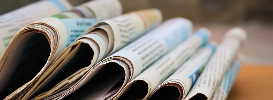 Stack of newspapers on wooden table