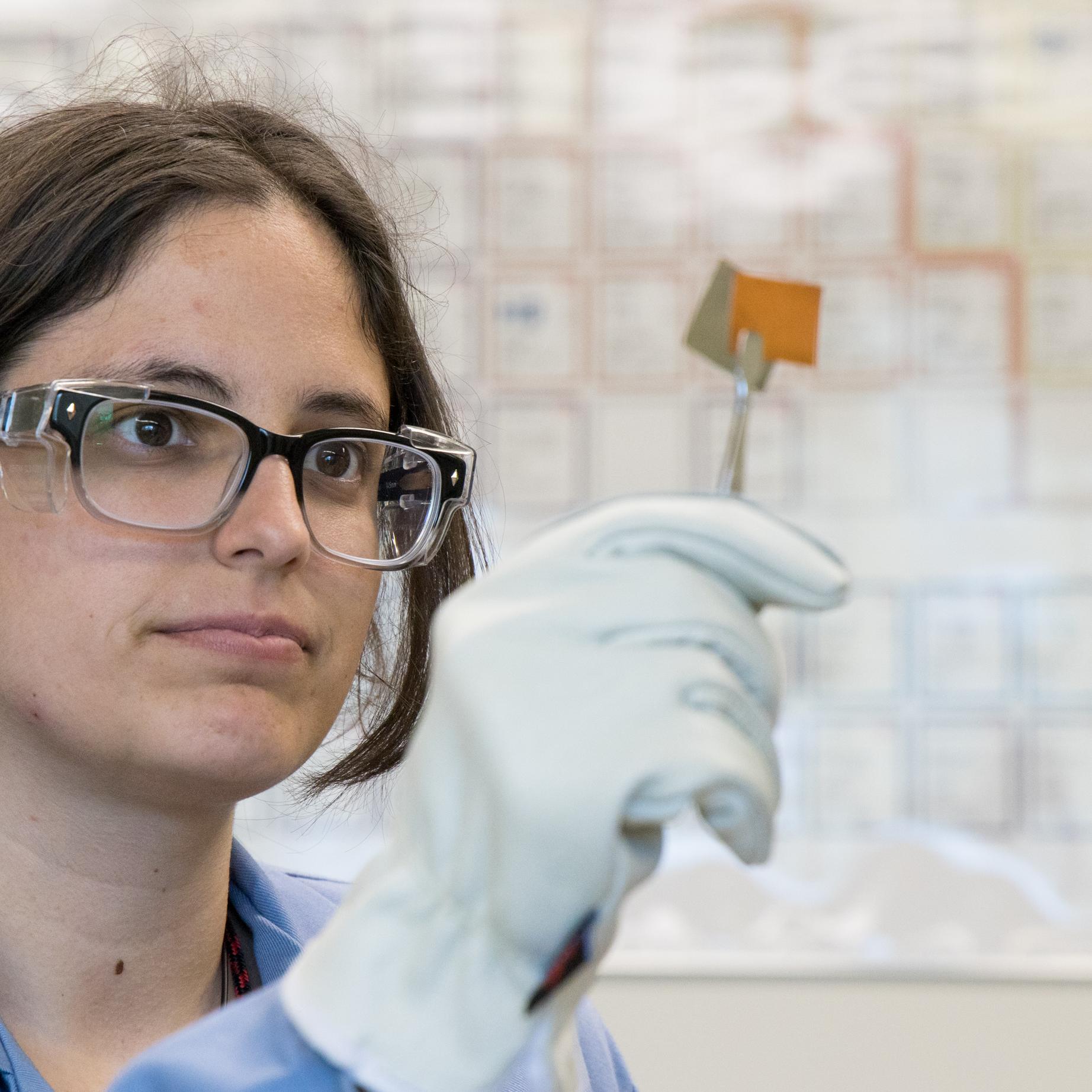 Scientist looking at metal foils