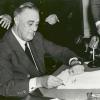 President Franklin Delano Roosevelt signing the Federal Credit Union Act in 1934.