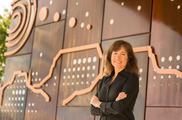 Susan Rempe stands in front of the Center for Integrated Nanotechnologies, where some of her research on bacterial pumps was done.