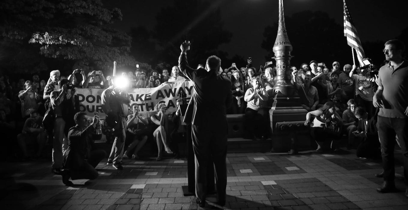 Senate Democratic Leader Chuck Schumer speaks at a healthcare rally at night