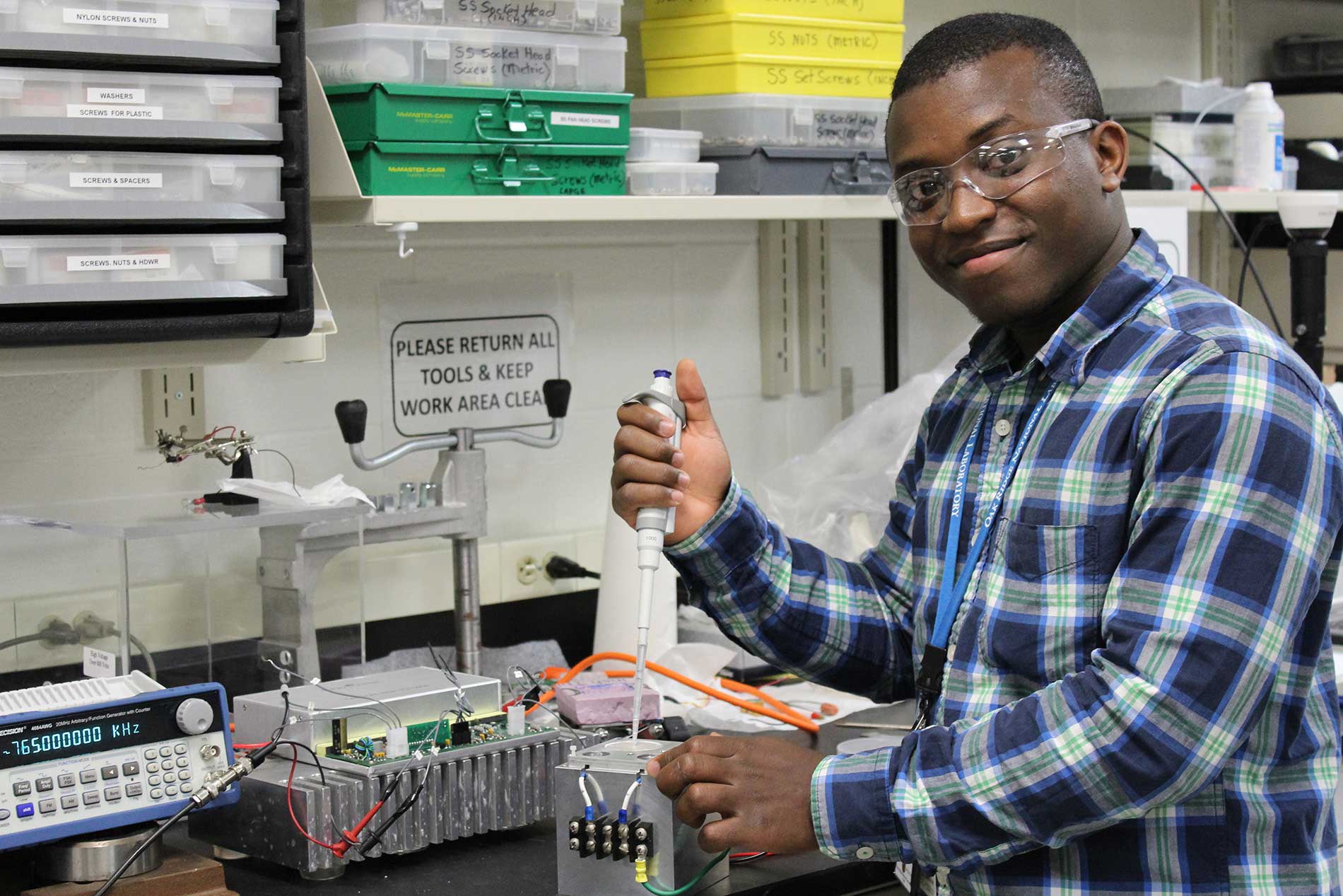 Male student researcher conducting experiment in laboratory