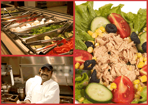 Smiling food service worker at a salad bar