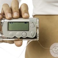 A person holding a blood glucose meter
