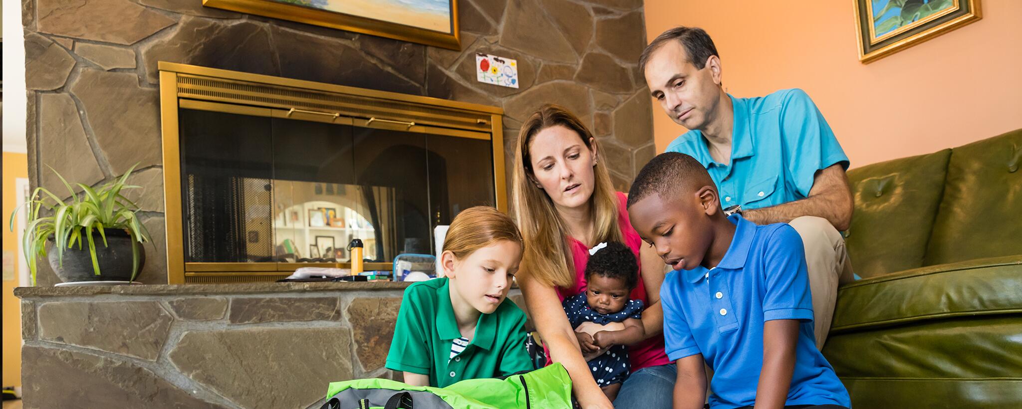 a family building an emergency supply kit. Staying home saves lives. #AloneTogether