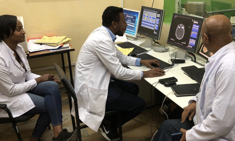 A doctor in Ethiopia uses a CT simulator donated by the IAEA through the Peaceful Uses Initiative to analyse a scan of a patient. (Photo: M. Gaspar/IAEA)