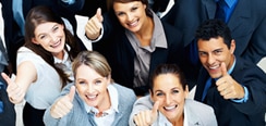 a group of people in business attire with hands raised