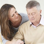 Older man and his daughter looking sad