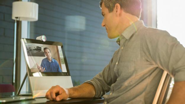 Photo of a man at home using a videophone