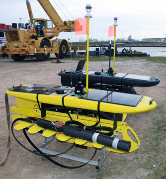 Two wave gliders waiting to be loaded onto a ship in Freeport, TX