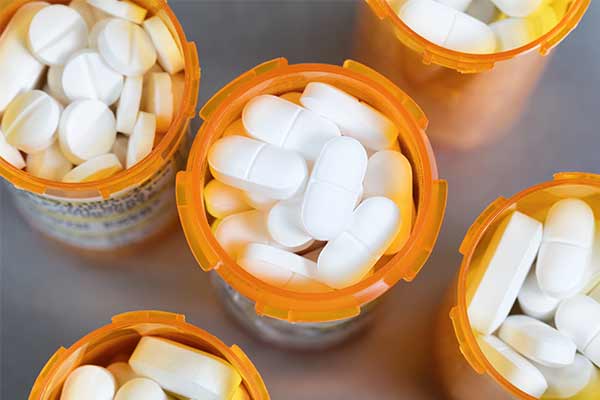 Top view of prescription medicine bottles on a stainless steel background