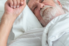 Older adult man lying bed who cannot sleep.