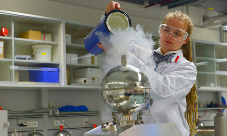 Female employee working in in a complex laboratory set-up. Photo: IAEA/Dean Calma.