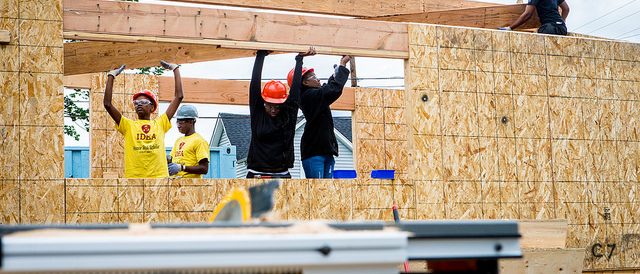 Students building a house during IDEA school visit