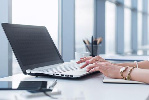 Person typing on a laptop 