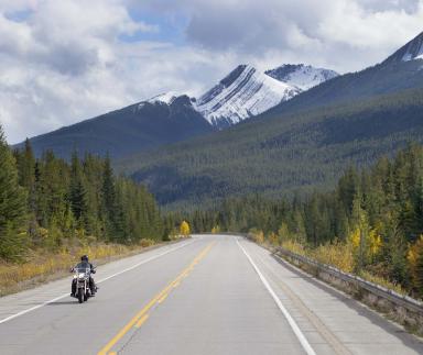 A motorcycle with mountains in the foreground.