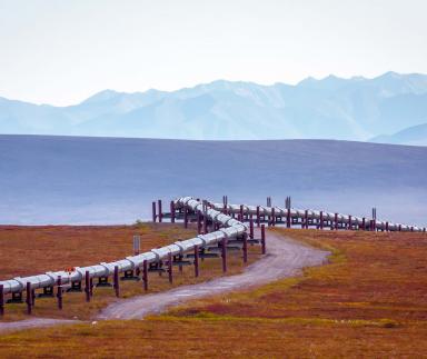 A pipeline with mountains in the background.