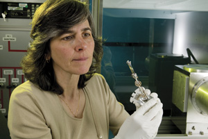 <h3>NIF Target</h3>Target fabrication manager examines a NIF hohlraum, a pencil-eraser-sized cylinder that holds the fusion target, a spherical capsule no larger than a peppercorn.<br/><br/><a href="content/assets/images/media/photo-gallery/large/nif-0209-15911_01.jpg" target="_blank">Download hi-res image</a><br/><a href="/media/photo-gallery?id=nif-0209-15911_01">Direct Link</a>