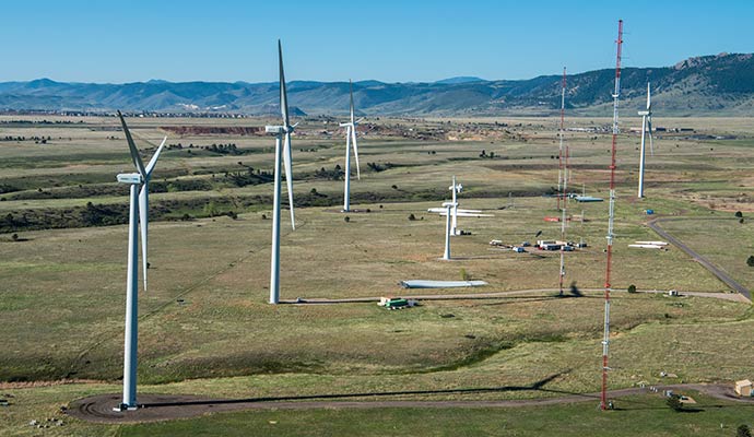 An aerial photograph of an energy laboratory campus with wind turbines.