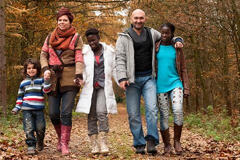 Family walking through the forest in fall