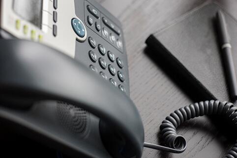 Picture of a black Phone sitting on a table