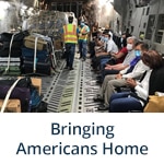"Bringing Americans Home" subheader with photo of Embassy Panama City Staff Assist U.S. Citizens Returning Home (Flickr, State Department Photo)