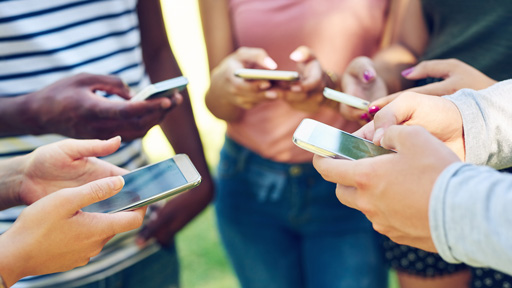 group of people all viewing phones