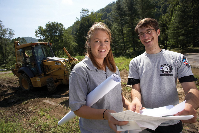 Two AmeriCorps members look over papers before beginning a project