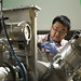 Researcher Di Chen loading nanolayered metal specimens for helium implantation into a Danfysik Research Ion Implanter at the Los Alamos National Laboratory Ion Beam Materials Laboratory. Chen is a Texas A&M University collaborator with Los Alamos scientists. 