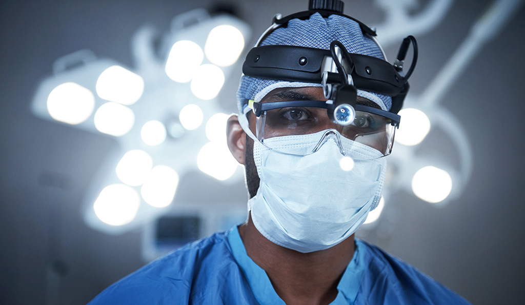 Shot of a surgeon wearing a surgical cap, mask and goggles | Photo Credit: iStockphoto-592648050 | Copyright: shapecharge
