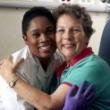 Image of a nurse embracing a cancer patient