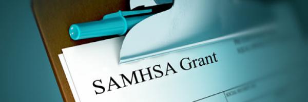 photograph of a clipboard with a SAMHSA Grant Application