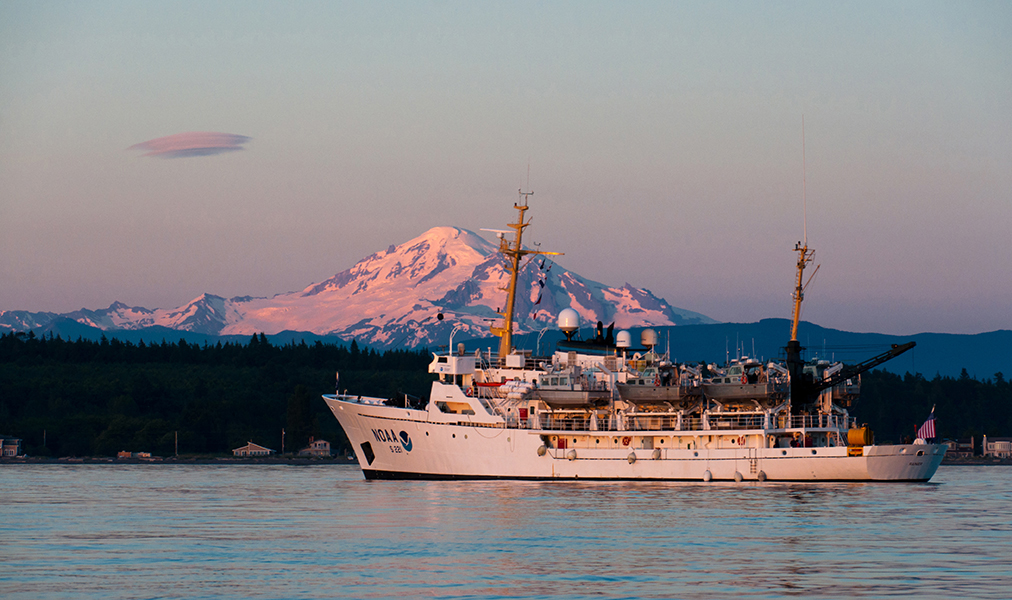 Sun setting on NOAA Ship Rainier with Mount Baker in the background.