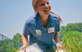 U.S. Department of Agriculture Outreach and Education Coordinator Annie Ceccarini with the master plan in one hand and a native grass plant in the other, she manages the creation of the People’s Garden, at William B. Powell Elementary School on Thursday,