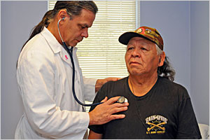 A provider checking a patient.